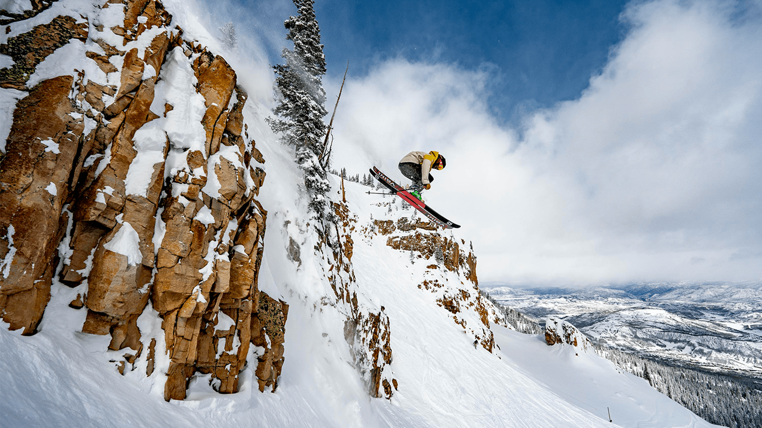 Skier jumps off cliff at Aspen Snowmass