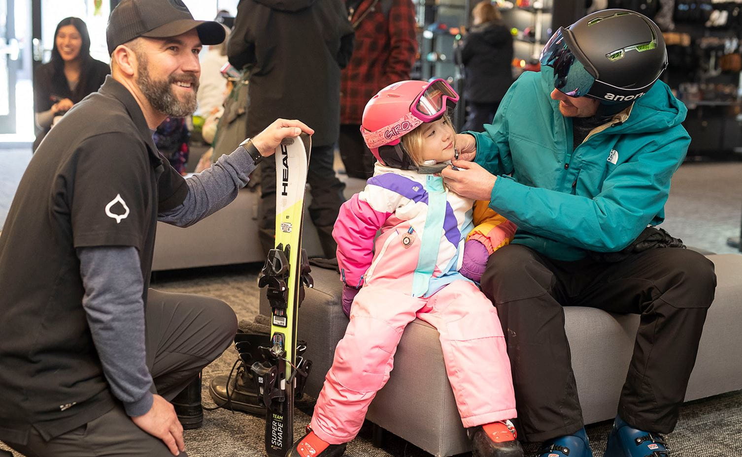 A young child gets ski rentals at Four Mountain Sports