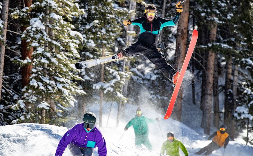 Group of skiers skiing through a mogul field. 