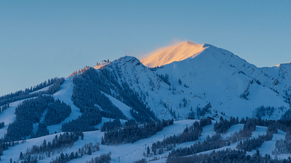 sunrise on the aspen highlands bowl, the rest of highlands ski runs are still in the shade of dawn