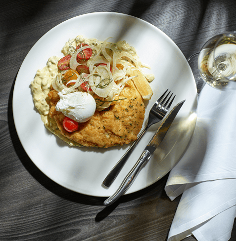 chicken schnitzel on a white plate at the Alpin Room 