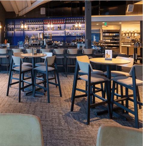 Interior of Buttermilk Mountain Lodge, tall tables in front of bar