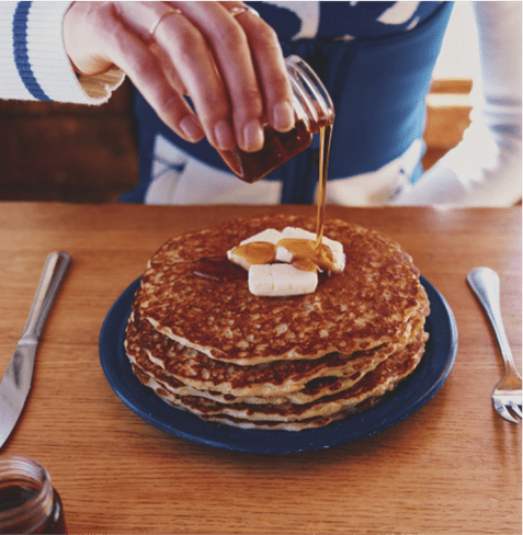 delicious stack of warm pancakes at Bonnies on Ajax, slaps on butter on top