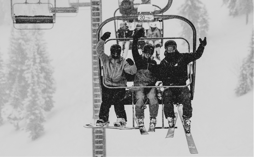 black and white image of people on lift at Aspen Snowmass