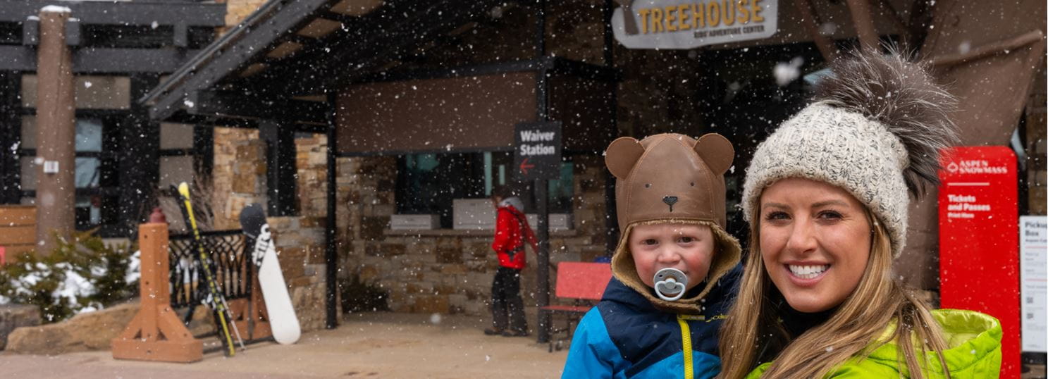 mother and son smile in front of the treehouse child care in snowmass