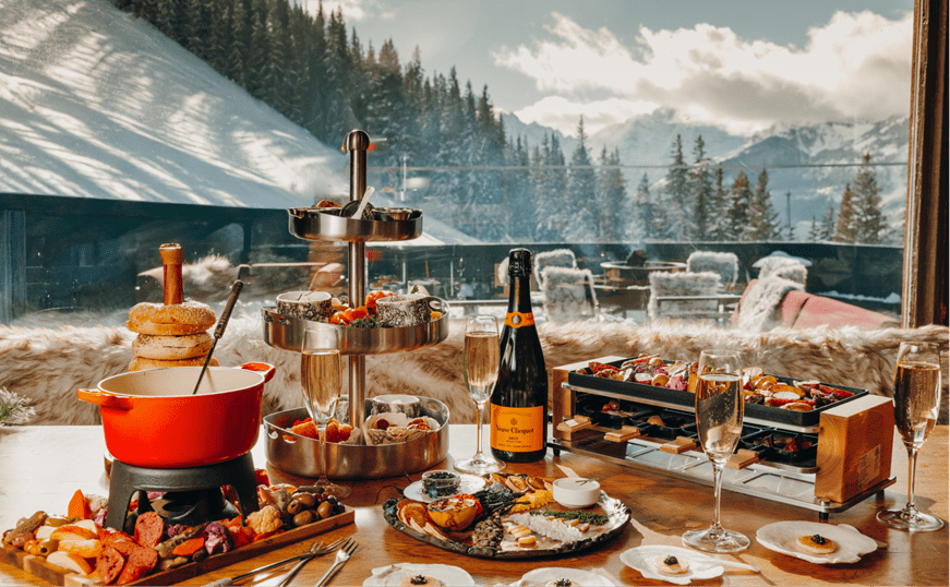 set table with food and drink at cloud nine alpine Bistro, varies dishes, fondue and champagne 