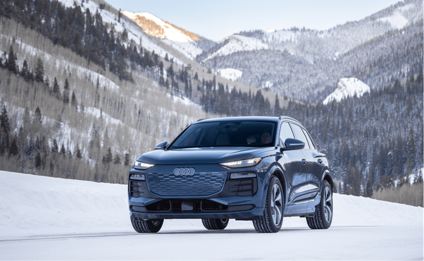 Electric audi on snowy peak on winter morning