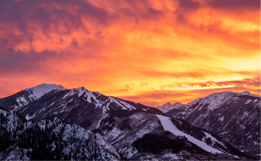 sunset over aspen mountain during the winter