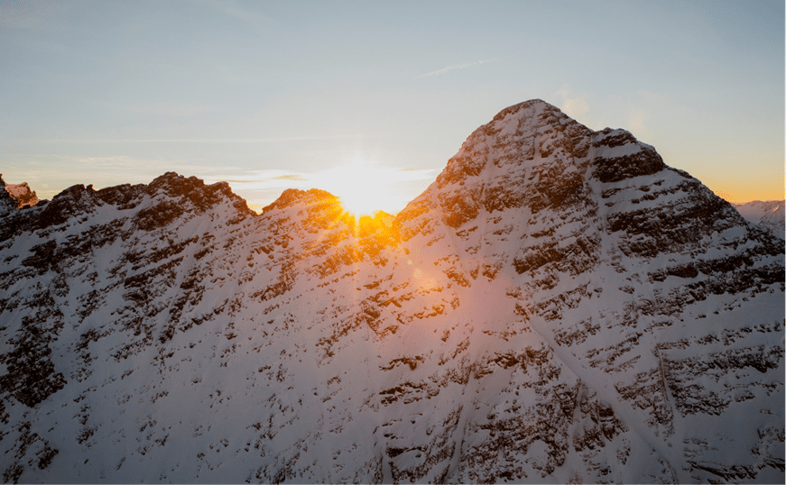 Sun over snowy peaks at Aspen Snowmass