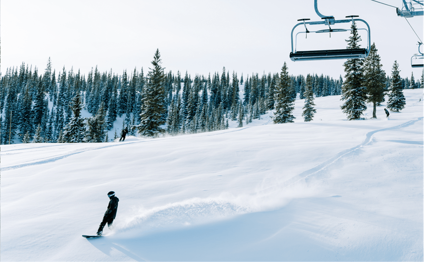 single rider under lift at Snowmass in deep powder