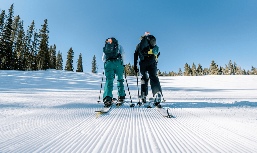 Two people Uphill up aspen mountain on a snowy day