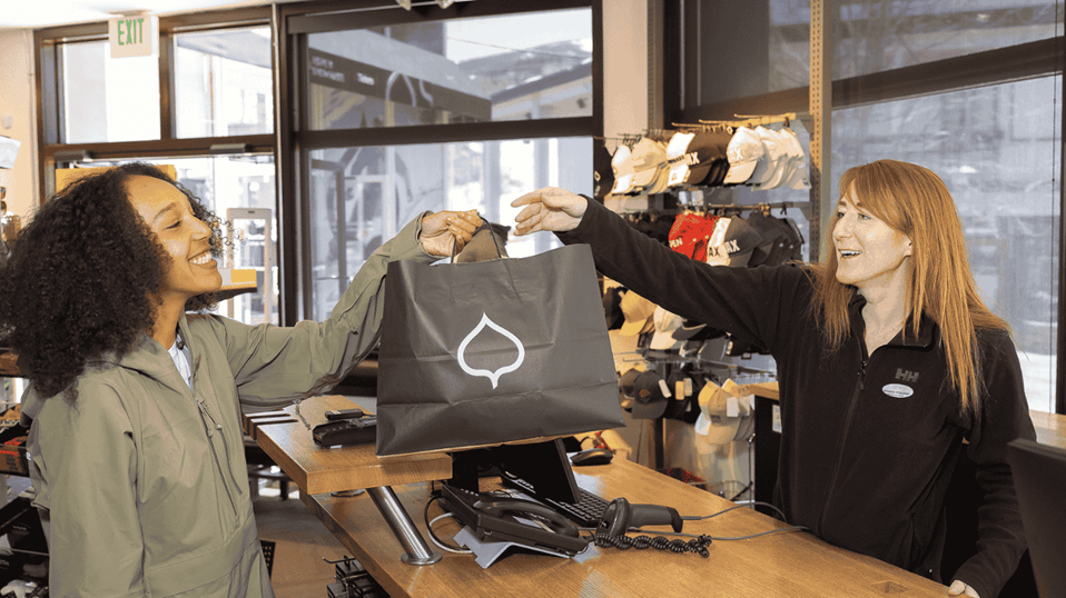 Rental Retail employee handing a FMS bag to a customer.