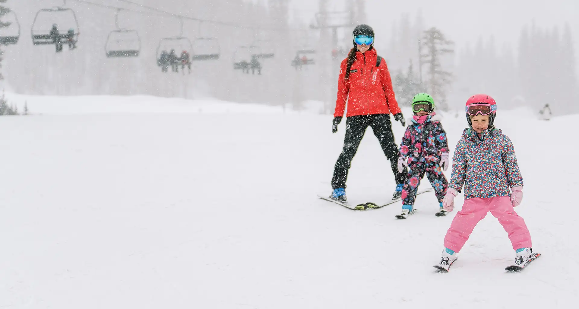 Ski instructor with two kid skiers at Snowmass