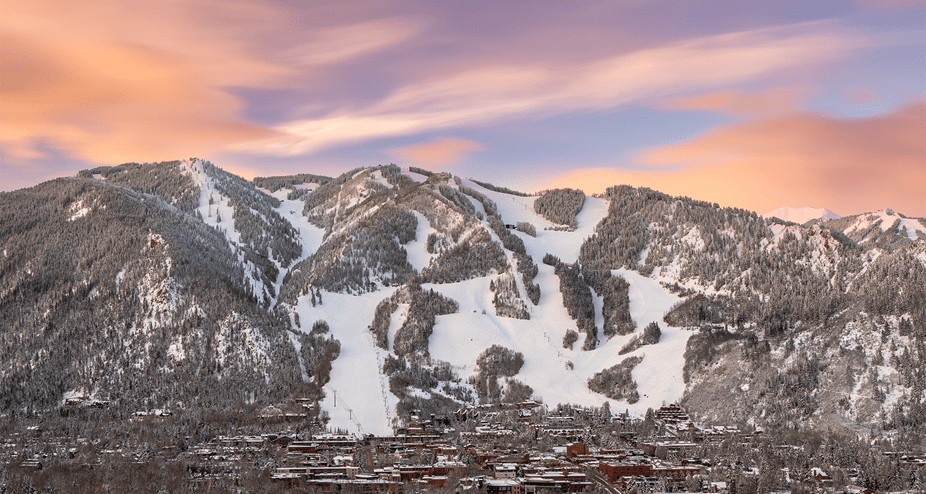 Sunrise over Aspen Mountain, pink and blue skies over the mountain and town