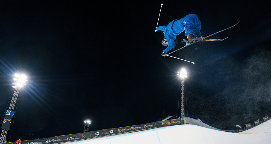 Skier above the half pipe at xgames at aspen snowmass