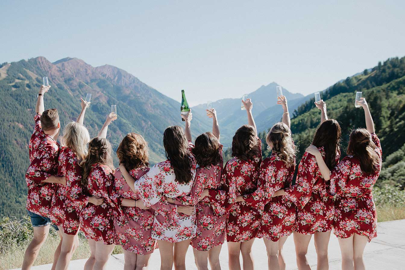 A bride and her bridesmaids toast to the mountains at Cliffhouse, Buttermilk, Aspen, Colorado wedding