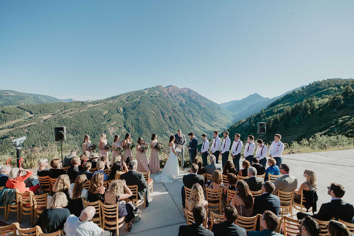 Wedding ceremony with Pyramid Peak in the distance at Cliffhouse, Buttermilk, Aspen, Colorado wedding