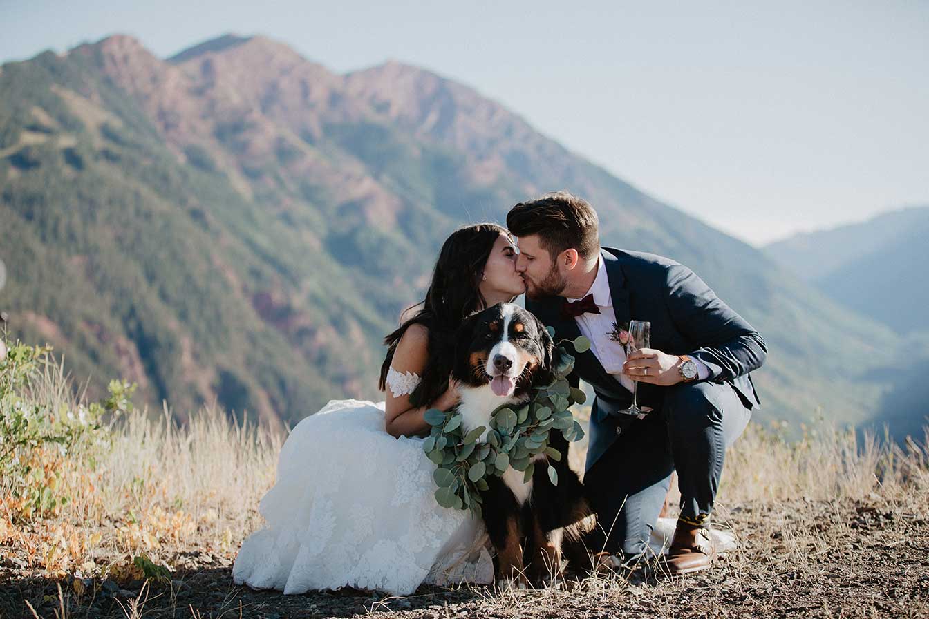 Bride and groom with their dog kissing at Cliffhouse, Buttermilk, Aspen, Colorado wedding