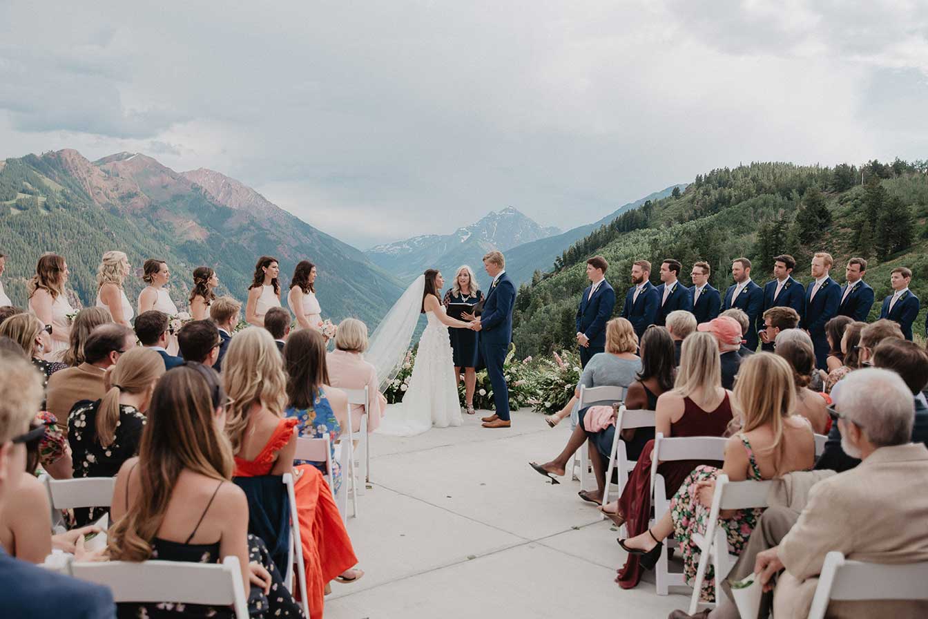 A view down the aisle at the wedding part during vows at Cliffhouse, Buttermilk, Aspen, Colorado wedding