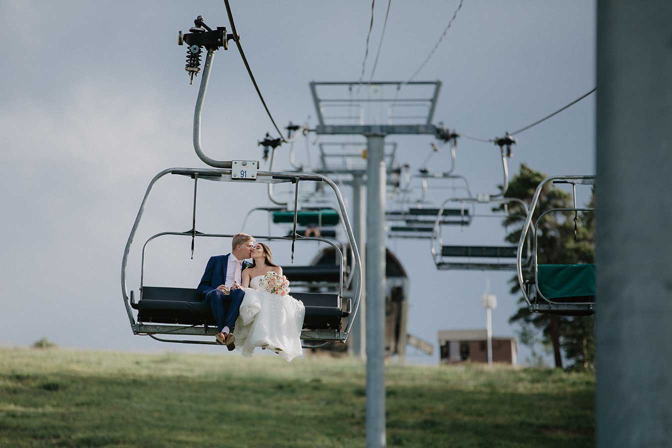 Bride and groom kiss on a ski lift at Buttermilk, Aspen, Colorado wedding