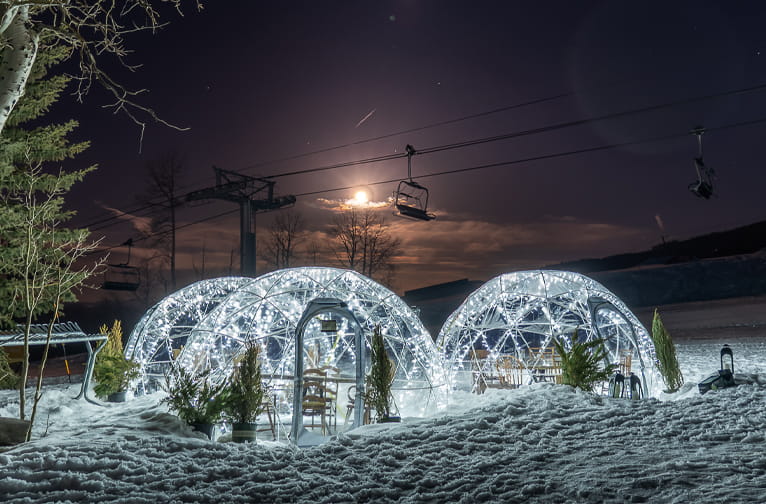 Outdoor dining domes under the riding full moon at Aspen Snowmass