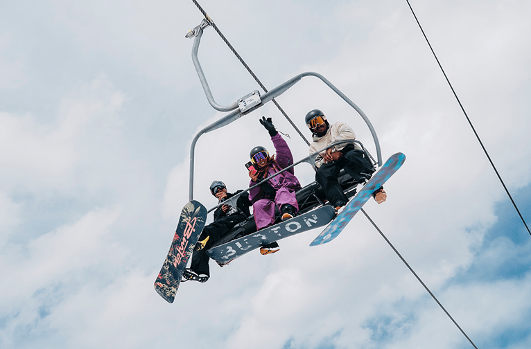 Culture Shifters event with three people on chairlift posing for camera