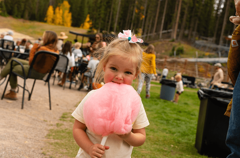 Little girl eating cotton candy
