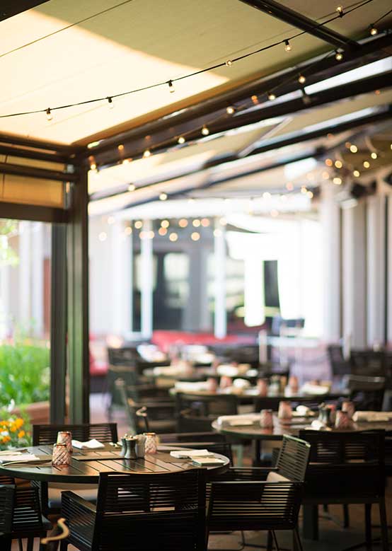 Summer outdoor seating at Element 47, one of many dining options at Aspen Snowmass.