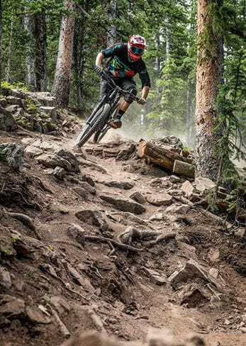 A rider tackles a difficult trail at Snowmass Bike Park