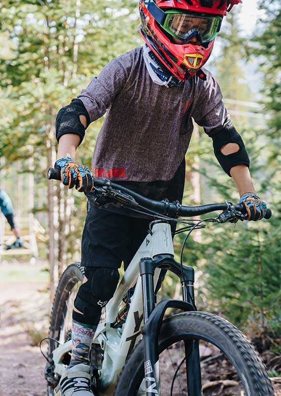 Young boy mountain biking at the Snowmass Bike Park