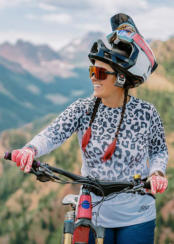 Woman takes a break from mountain biking atop Snowmass