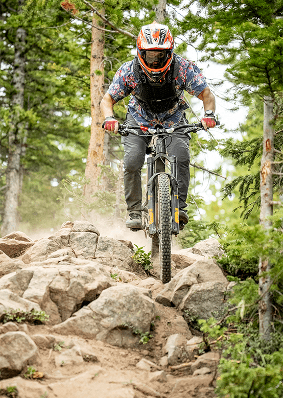 Downhill biker navigates rocks at the Snowmass Bike Park