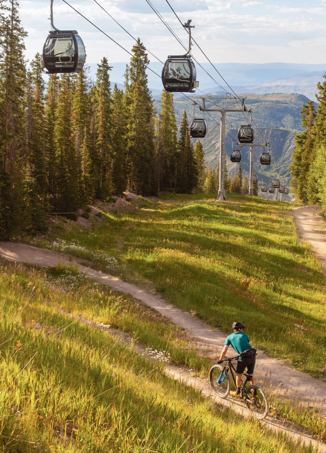 Biker under the Snowmass gondola