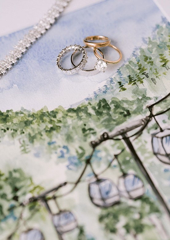 Drawing of Aspen Gondola, gold and silver wedding bands and engagement rings on drawing