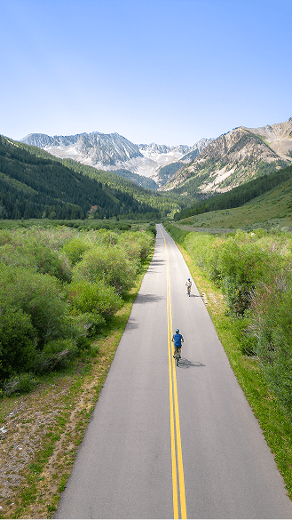 People biking on mountain road