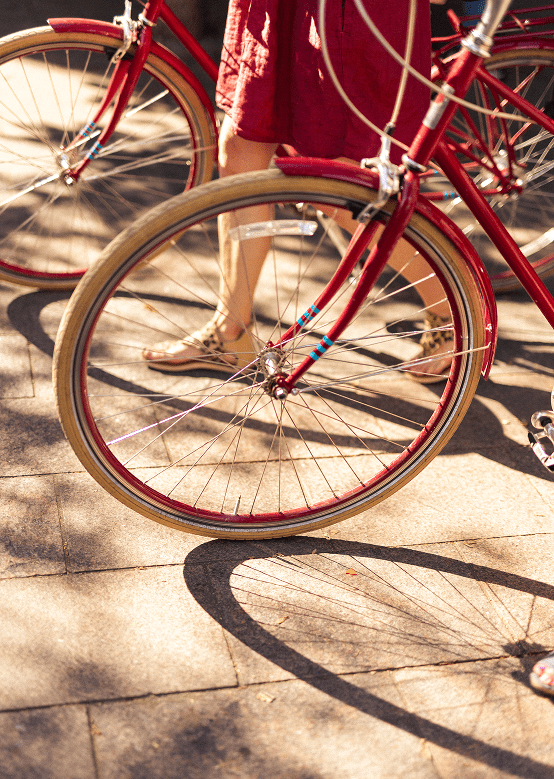 Red cruiser bikes with woman in red dress