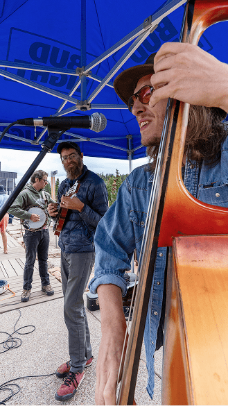 Group of men play bluegass music atop Aspen Mountain