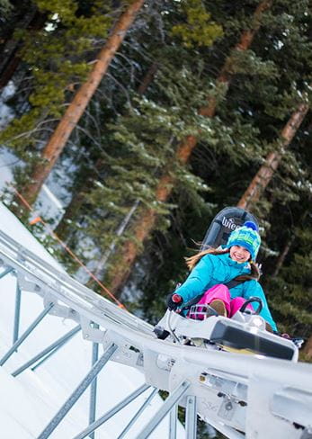 Kid going down the Breathtaker Alpine Coaster in Snowmass Colorado. 