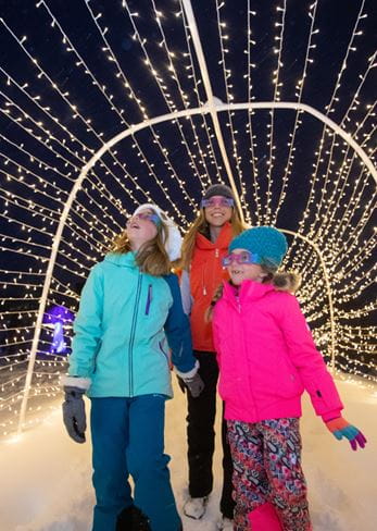 Family walking through lighted display at Snowmass Village