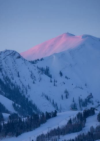 First light hits the top of Highland Peak