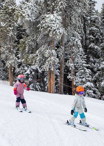 Two kids skiing at Buttermilk