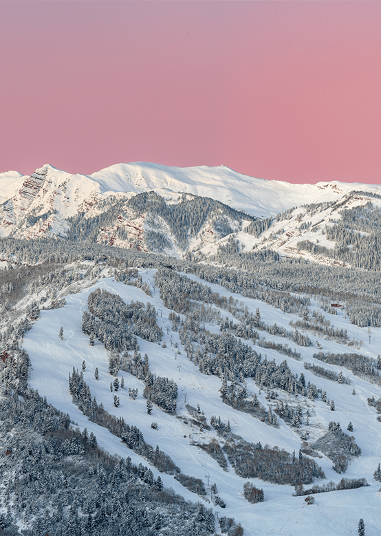 sunrise at Aspen Snowmass, over buttermilk. The Sky glows pink.