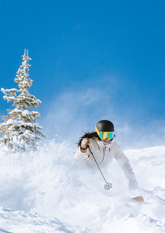 skier in deep powder on a bluebird day