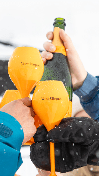 people cheers their yellow plastic champaign flutes