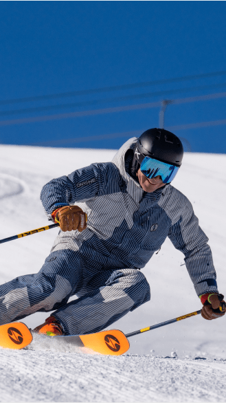 Man carves a tight turn in the freshly groomed snow at aspen snowmass