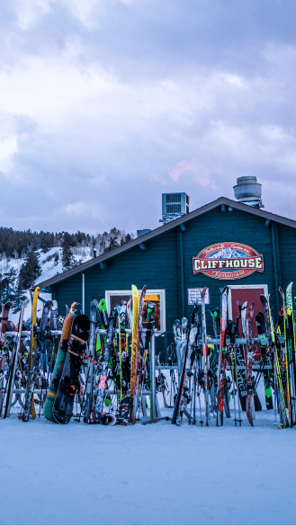 Cliffhouse at dawn, green building under light blue skies