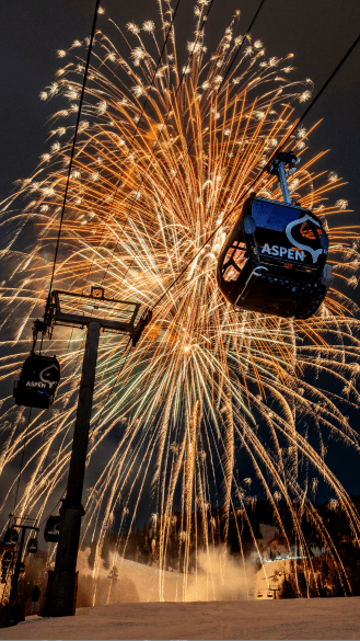 Fireworks explore over the aspen gondola at night