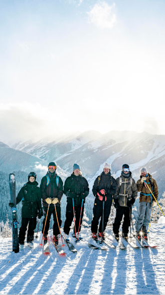 group of people smile for the camera on a scenic lookout at Buttermilk 