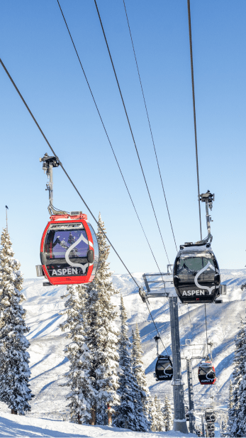 Aspen Mountain Gondola moving people up the mountain on a blue bird day