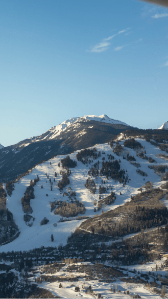 Aerial view of Buttermilk under blue skies, on a snowy winter day